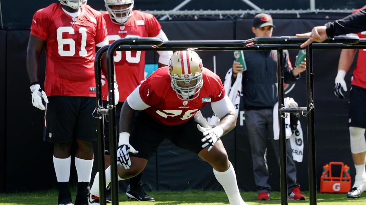 The 49ers’ Anthony Davis, front, goes through drills during training camp Sunday, July 31, 2016, in Santa Clara, Calif.