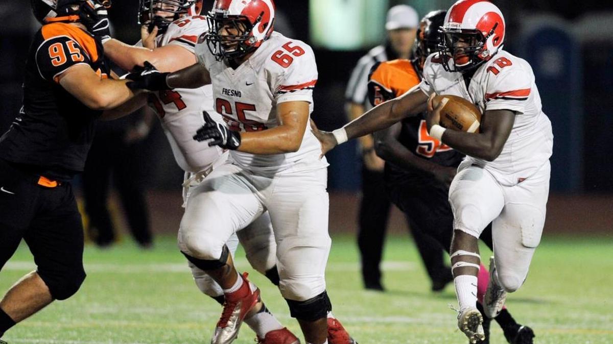 
Fresno City College running back Nate Jones tries to follow his blocks into a gain against Reedley in the second half of the teams’ game on Oct. 3, 2015.
