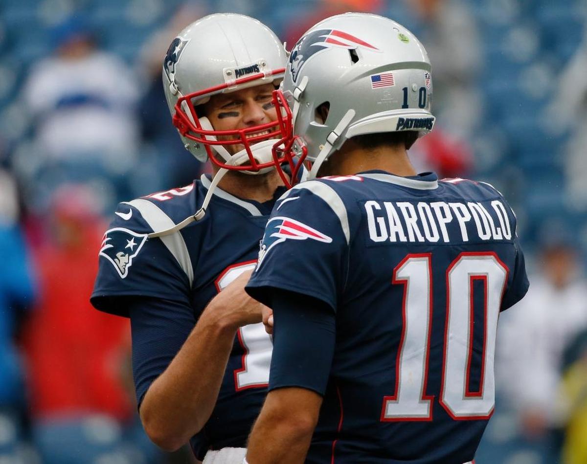 New England Patriots quarterbacks Tom Brady, left, and Jimmy Garoppolo warm up before Sunday’s game against the Los Angeles Chargers. Garoppolo was acquired by San Francisco in a trade deadline deal, a move David Carr said gives the 49ers a clearly defined direction and an intriguing future.