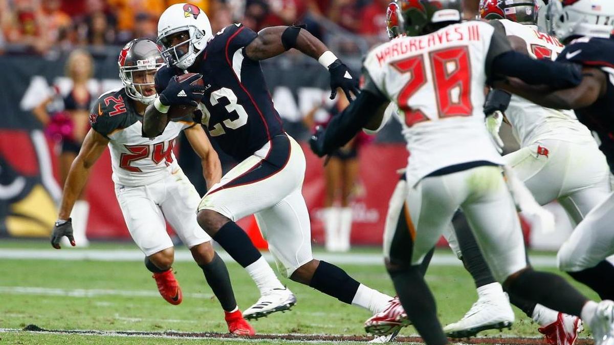 Arizona running back Adrian Peterson races through a hole and past Tampa Bay Buccaneers cornerbacks Brent Grimes (24) and Vernon Hargreaves (28) during the second half of the Cardinals’ 38-33 victory Sunday, Oct. 15, 2017, in Glendale, Ariz. Peterson rushed for 134 yards and two touchdowns in his Arizona debut and could make the Cardinals a playoff contender in a tough NFC West.