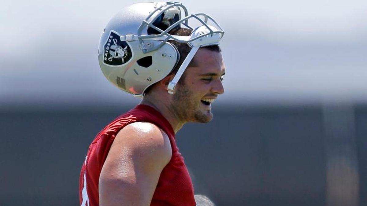 Oakland Raiders quarterback Derek Carr laughs during a break at the opening day of mandatory mini-camp on Tuesday, June 13, 2017, at the team’s training facility in Alameda.