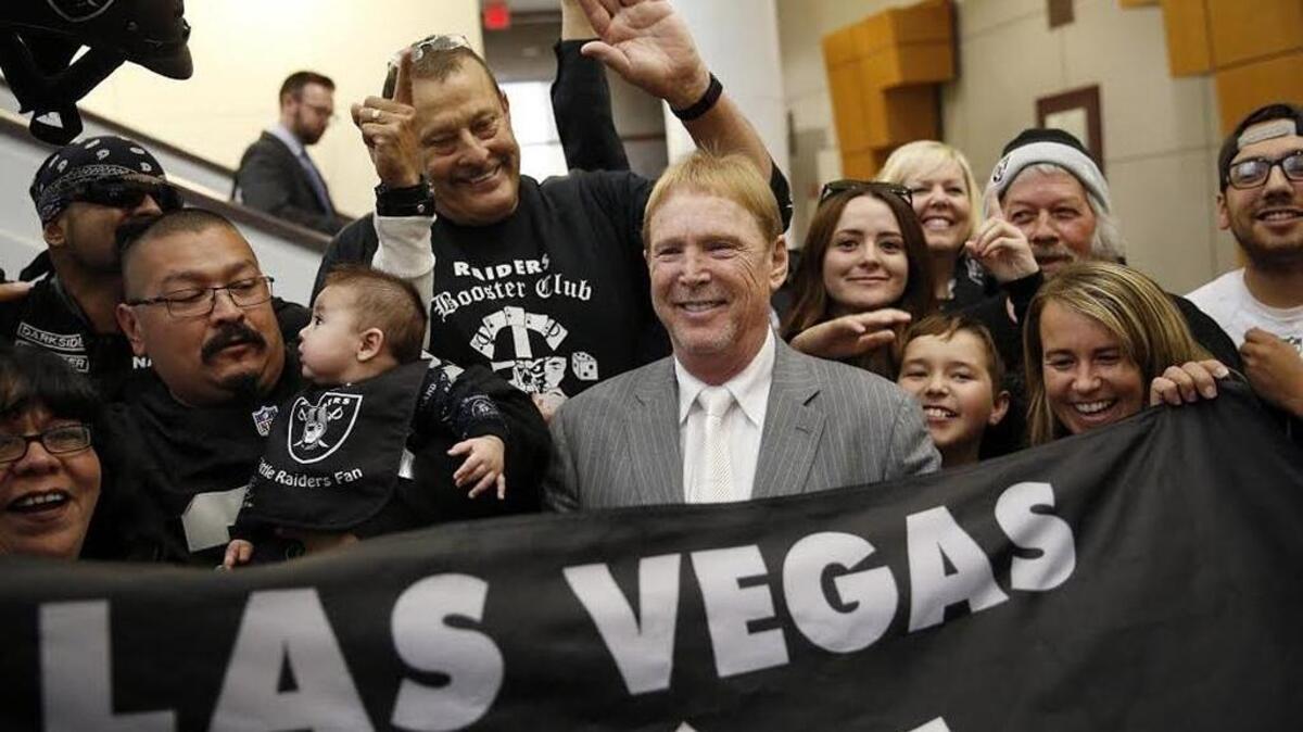 In this April 28, 2016, file photo, Oakland Raiders owner Mark Davis, center, meets with Raiders fans after speaking at a meeting of the Southern Nevada Tourism Infrastructure Committee in Las Vegas. NFL owners approved the Raiders’ move to Las Vegas on March 27, 2017.