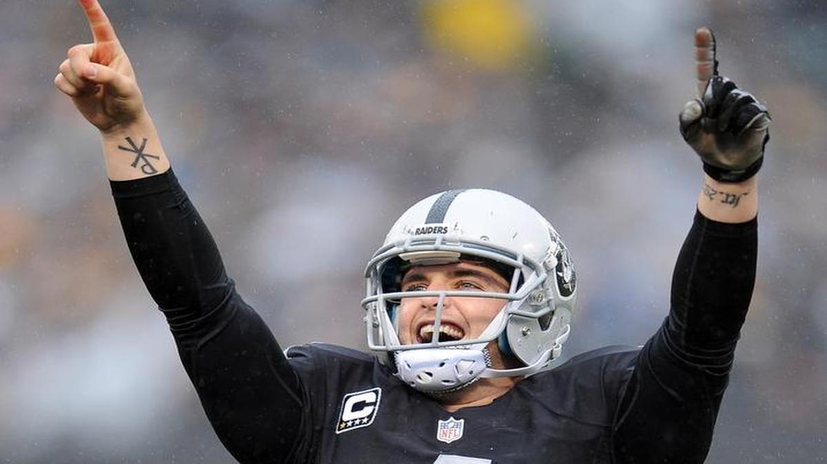 Oakland quarterback Derek Carr reacts after throwing a touchdown pass against Green Bay in a Dec. 20, 2015, game at O.co Coliseum. Carr, after throwing for 21 as a rookie, has 31 TD tosses this season heading into Sunday’s finale against Kansas City.