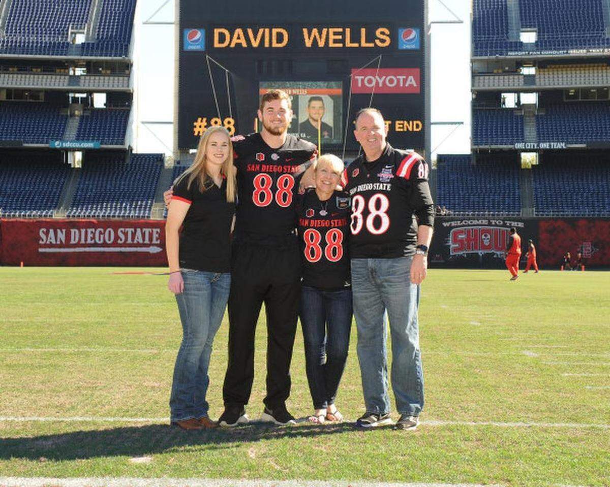 David Wells, center, is pictured with his sister Rebekah, left, stepmom Shari and dad Bryan.