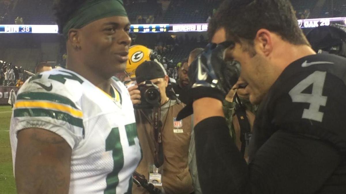 Green Bay Packers wide receiver Davante Adams and Oakland Raiders quarterback Derek Carr, both Fresno State alums, meet on the field following a December 2015 game. The pair spoke following Carr’s surgery on Tuesday for a season-ending leg injury.
