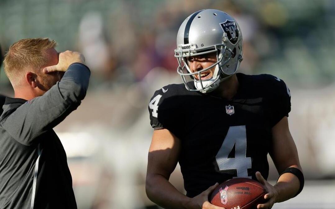 Oakland Raiders quarterback Derek Carr has a new offensive coordinator, Todd Downing, left. No matter, says Carr, the offense is ready to roll: “We’re more comfortable. We play faster.”