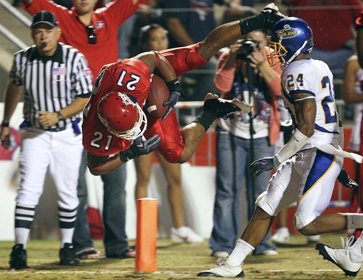 Fresno State’s Ryan Mathews dives into the end zone ahead of San Jose State’s Devin Newsome on a play negated by a penalty October 17, 2009. It was one of the few things that went against Mathews that year, when as a Bulldogs junior he ran for a national second-best 1,808 yards.