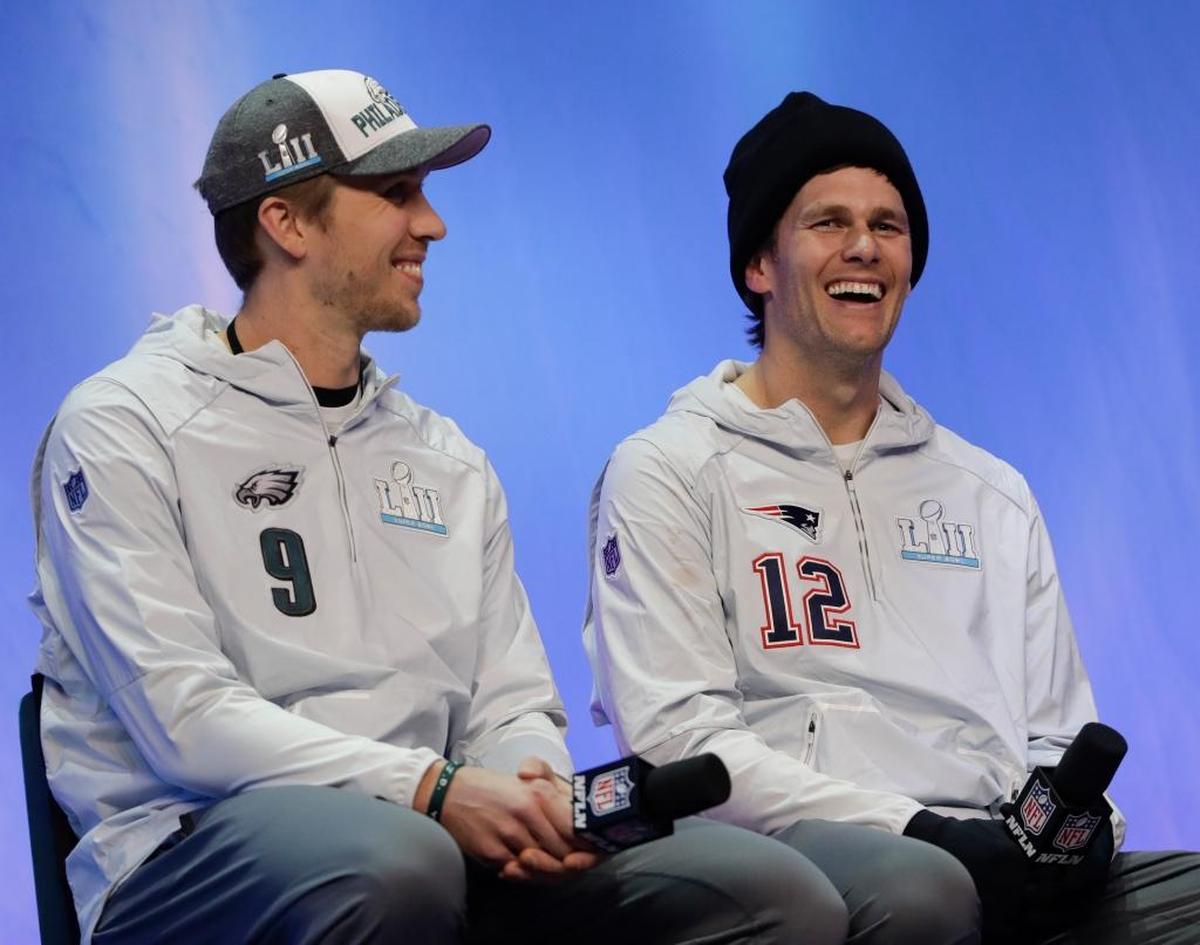 The Eagles' Nick Foles, left, and the Patriots’ Tom Brady answer questions during NFL football Super Bowl 52 Opening Night on Monday, Jan. 29, 2018, at the Xcel Center in St. Paul, Minn.