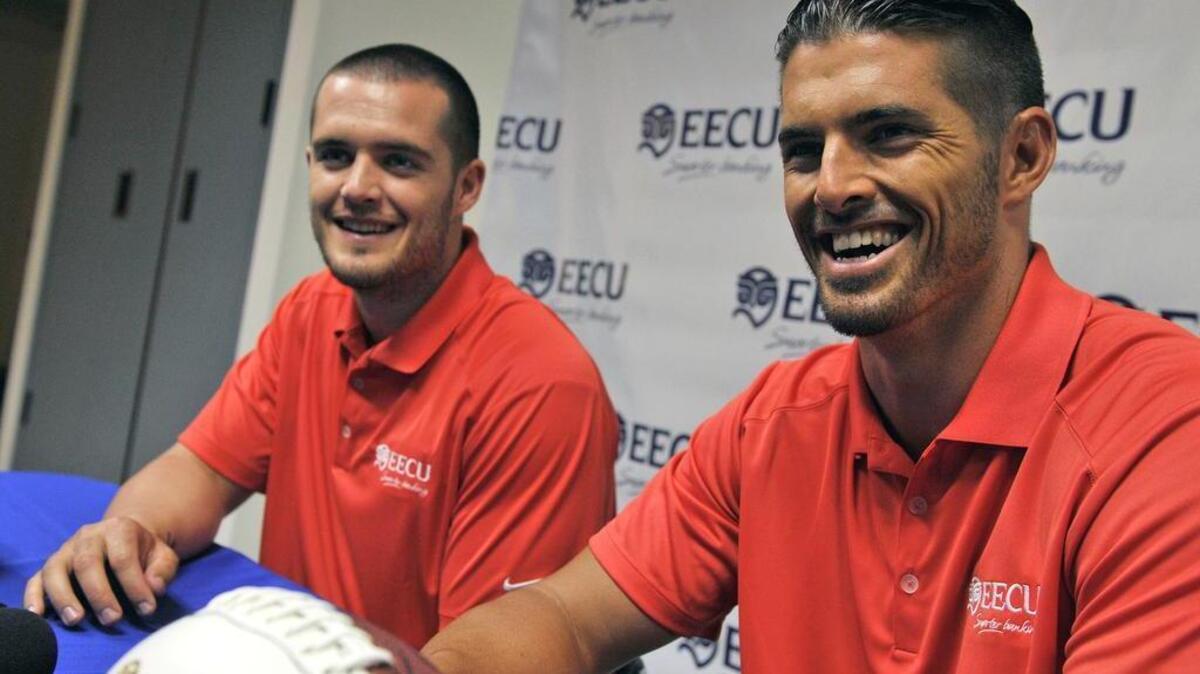 In a 2014 file photo, former Fresno State quarterbacks Derek Carr, left, and brother David Carr speak to the media after announcing their endorsement of Educational Employees Credit Union.