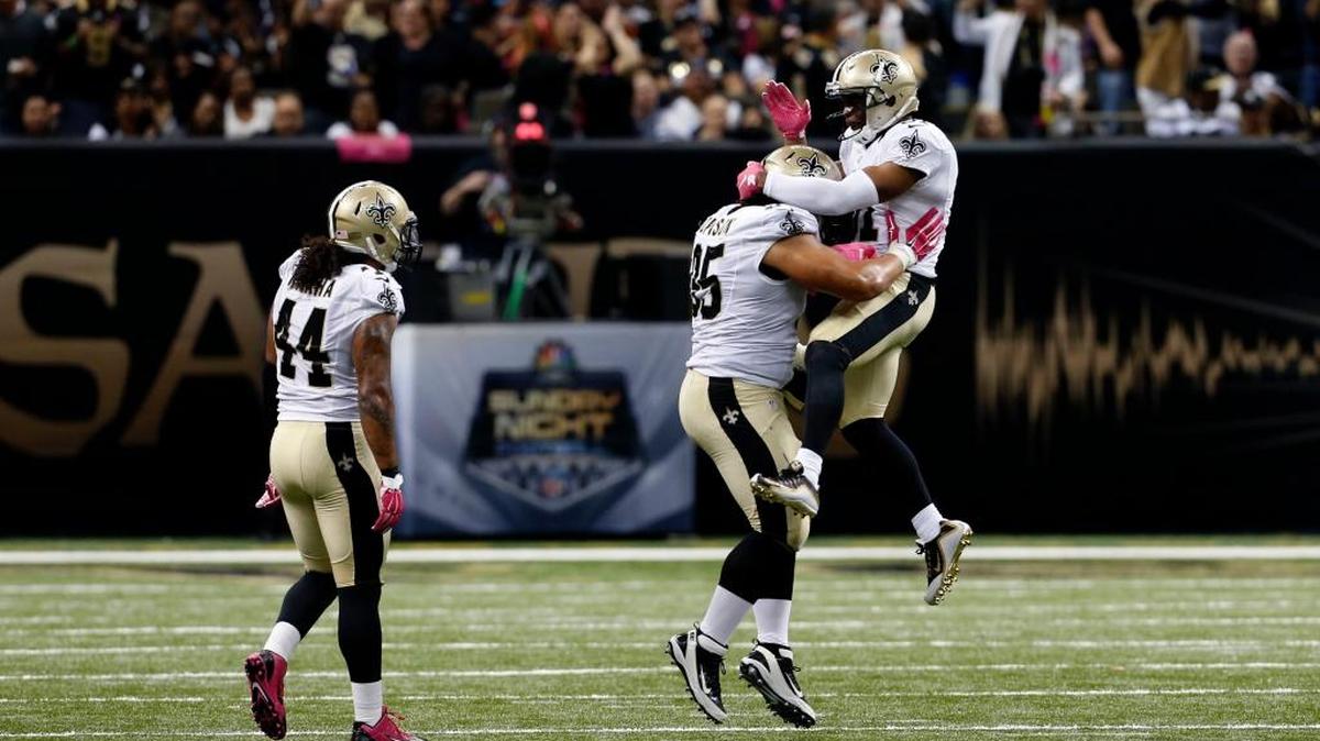 
New Orleans Saints free safety Jairus Byrd leaps onto defensive tackle Tyeler Davison after a sack in the fourth quarter against the Dallas Cowboys,

