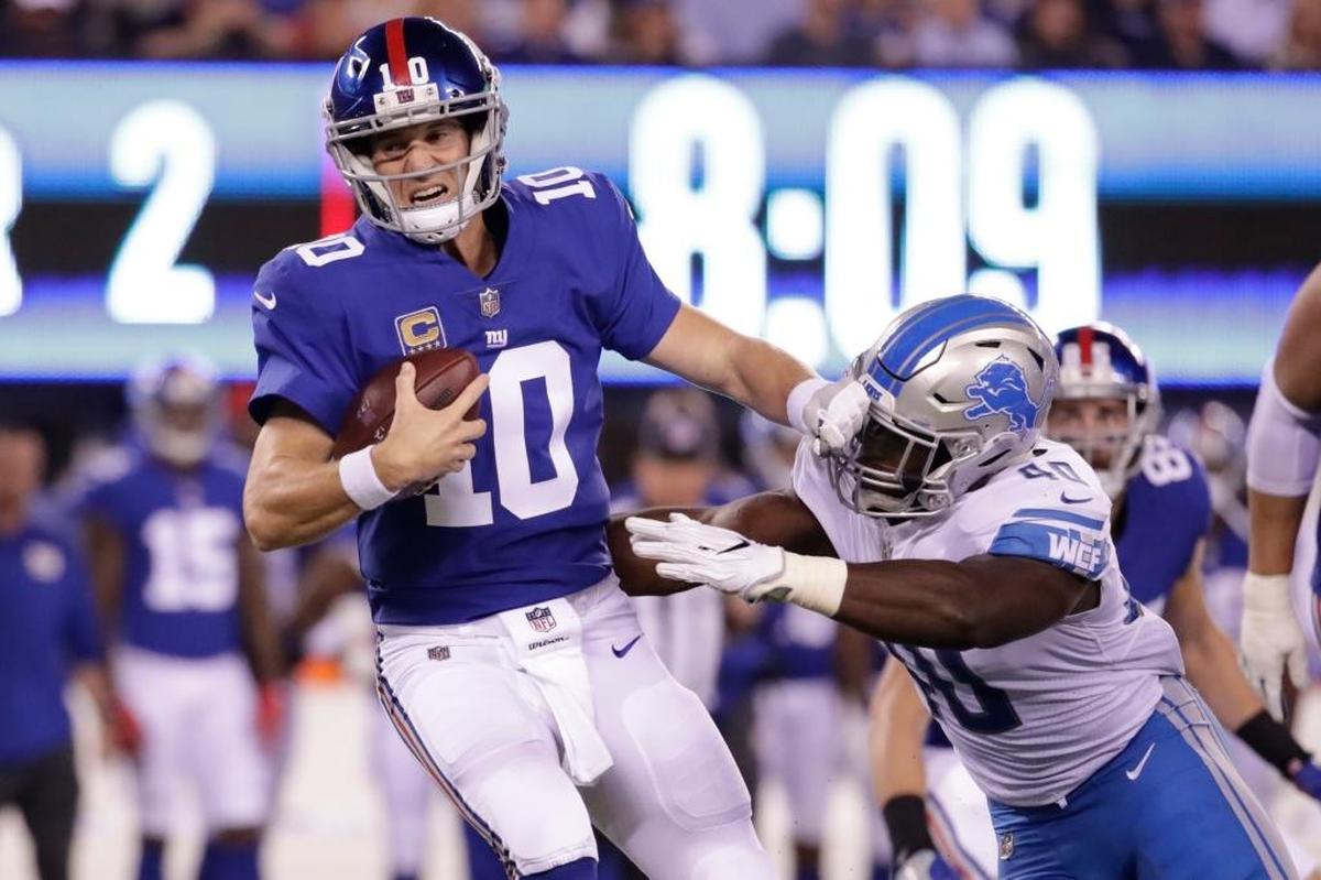 New York Giants quarterback Eli Manning (10) is sacked by Detroit Lions' Jarrad Davis (40) during the first half of an NFL football game Monday, Sept. 18, 2017, in East Rutherford, N.J. Manning, who has two Super Bowl wins, is struggling this season with an offense that has been hurt by injuries.
