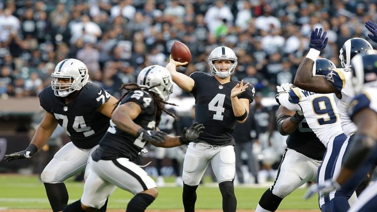 Raiders quarterback Derek Carr passes against the Los Angeles Rams during the first half of an NFL exhibition Saturday, Aug. 19, 2017, in Oakland.