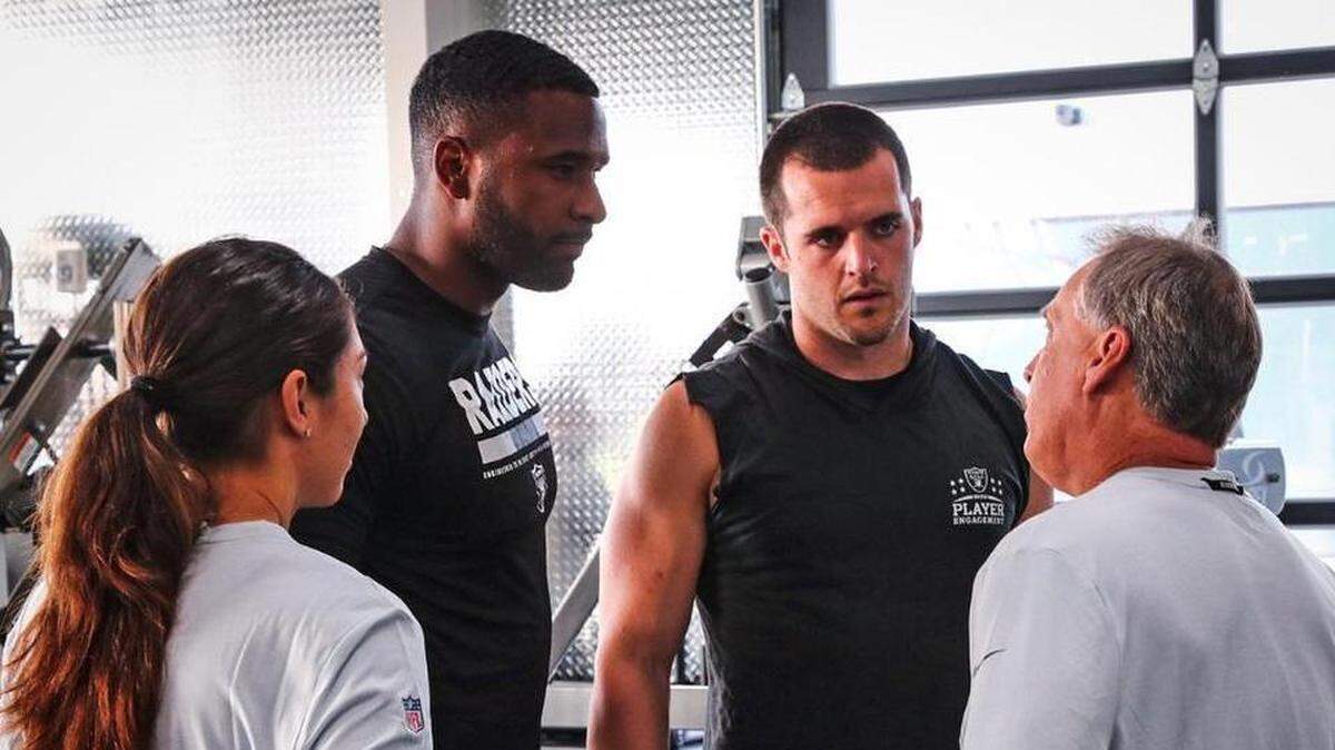 Oakland Raiders quarterbacks Derek Carr, right, and EJ Manuel, left, listens to strength and conditioning coach Tom Shaw on Monday, April 9, 2018. The Raiders began phase one of their offseason workout program.
