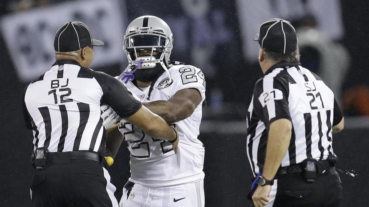 Oakland Raiders running back Marshawn Lynch makes contact with back judge Greg Steed as side judge Jeff Lamberth watches during the second half of the Oct. 19 game between the Raiders and the Kansas City Chiefs in Oakland. The NFL suspended Lynch for this week because of the unsportsmanlike conduct.