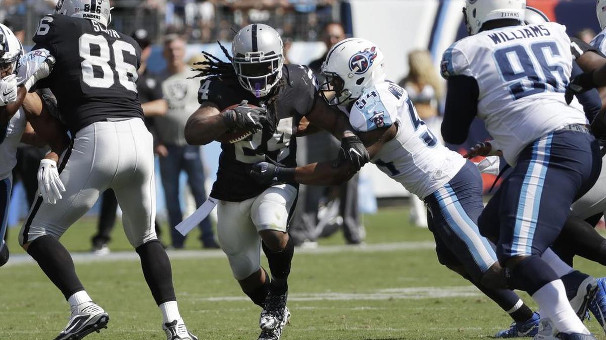 Raiders running back Marshawn Lynch sheds Tennessee Titans inside linebacker Avery Williamson 54 in the second half of Sunday’s game. Lynch finished with 76 yards on 18 carries.