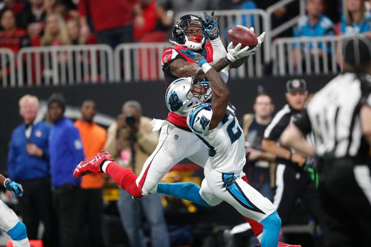 Atlanta wide receiver Julio Jones (11) vies for a ball against Carolina Panthers strong safety Mike Adams (29) during the first half of the Falcons’ 22-10 victory, Sunday, Dec. 31, 2017, in Atlanta. Jones caught five passes for 80 yards in the win.