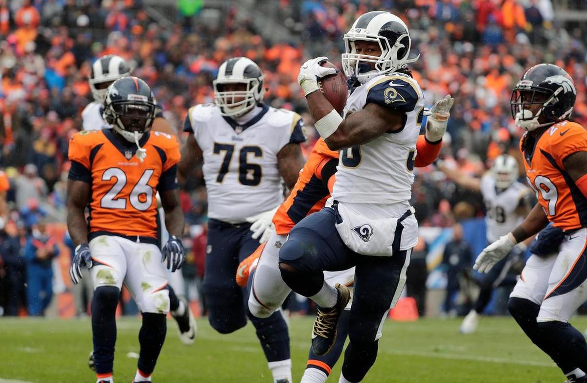 Los Angeles Rams running back Todd Gurley (30) scores against the Denver Broncos on a 4th and 1 play from the 10 yard line in the second quarter on Sunday, Oct. 14, 2018 at Broncos Stadium at Mile High in Denver. Gurley is one of the few running backs in the NFL to get a huge contract – $60 million over four years.