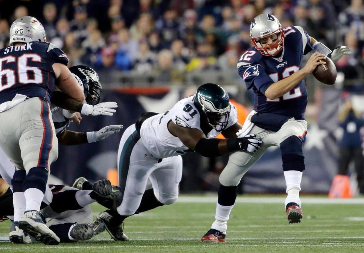 New England quarterback Tom Brady (12) scrambles away from Philadelphia defensive end Fletcher Cox (91) during the Eagles’ 35-28 victory over the Patriots in 2015. Cox, Malcolm Jenkins, Brandon Graham, Vinny Curry, Mychal Kendricks and Beau Allen are six key defensive players left from an Eagles team that beat Tom Brady and the Patriots in Foxborough, Mass.