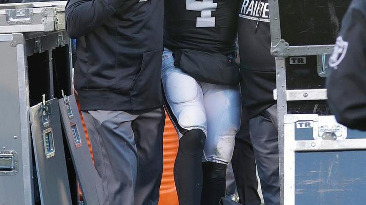 Oakland Raiders quarterback Derek Carr (4) is helped off the field after an injury during the second half of an NFL football game against the Indianapolis Colts in Oakland, Calif., Saturday, Dec. 24, 2016.