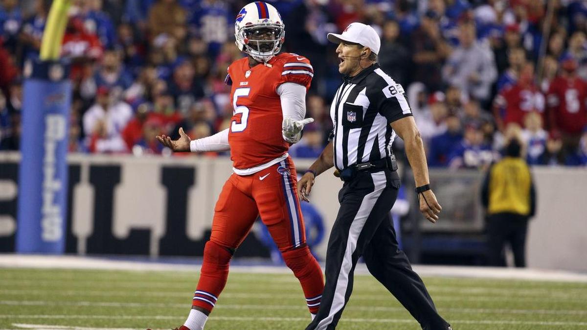 Buffalo Bills quarterback Tyrod Taylor (5) is walked off the field by referee Ed Hochuli during the second half an NFL football game against the New York Jets on Thursday, Sept. 15, 2016, in Orchard Park, N.Y.