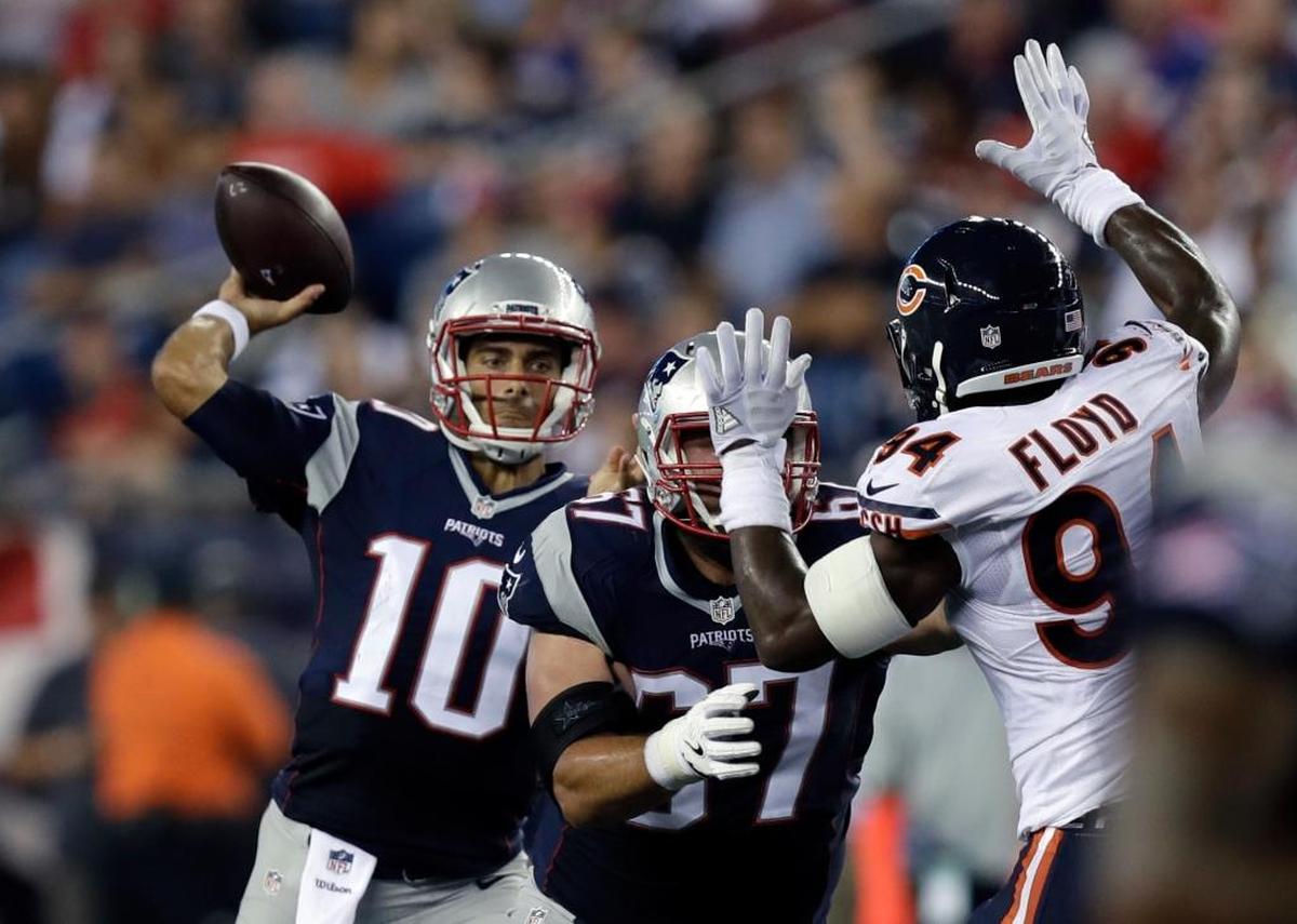 Quarterback Jimmy Garoppolo, acquired by the San Francisco 49ers from New England in a trade deadline deal, fires a pass while pressured by Chicago Bears linebacker Leonard Floyd during a 2016 exhibition game.