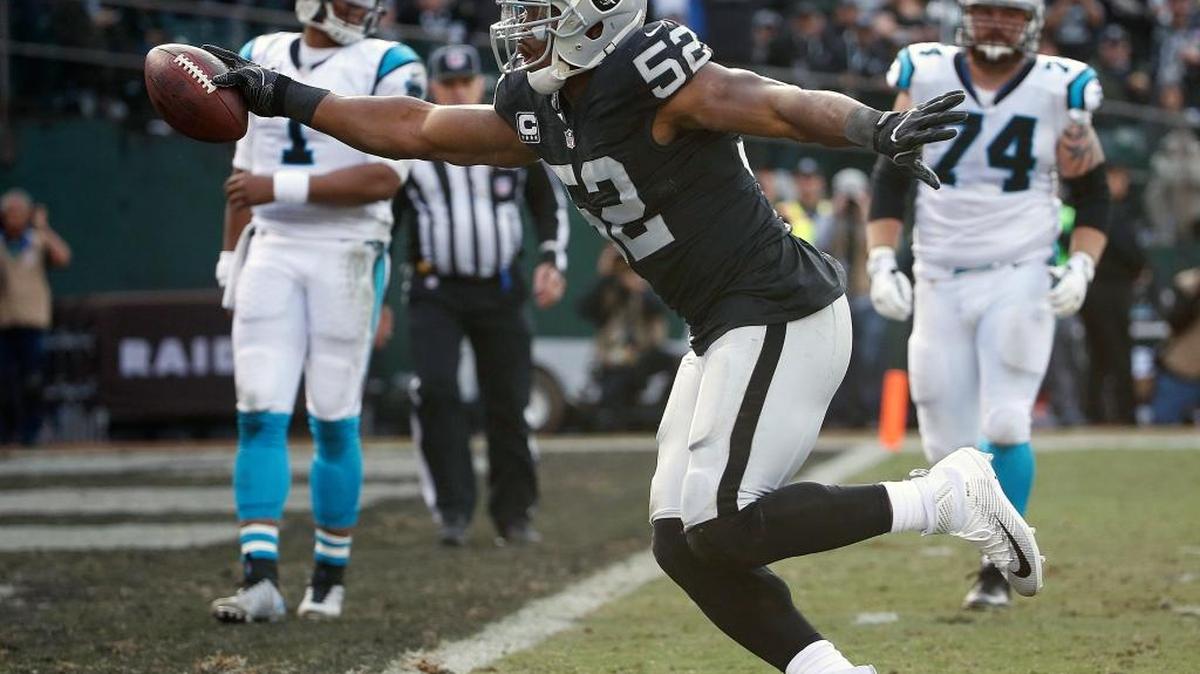 Oakland Raiders defensive end Khalil Mack (52) scores a touchdown after intercepting a pass from Carolina Panthers quarterback Cam Newton (1) in Oakland, Calif., Sunday, Nov. 27, 2016.
