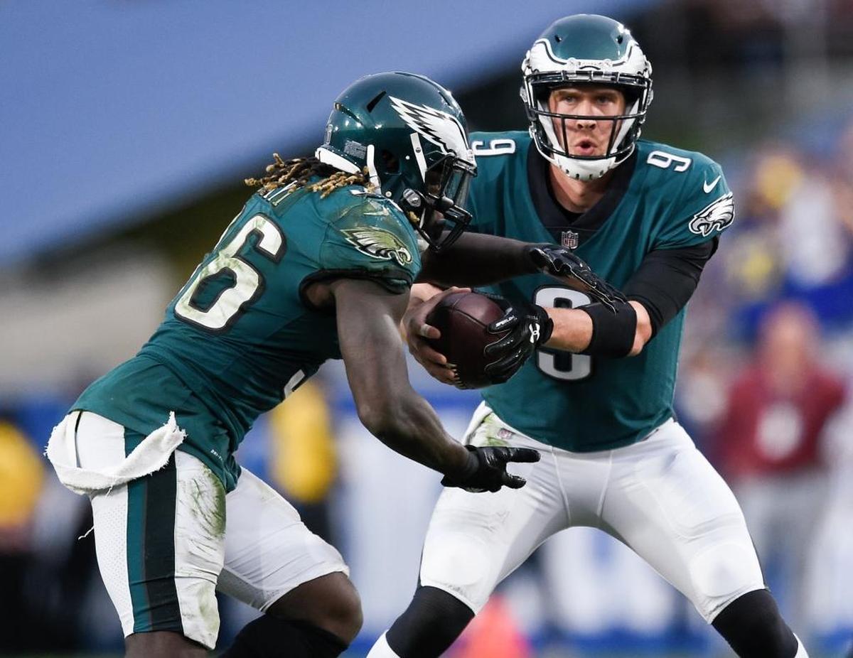 Philadelphia Eagles quarterback Nick Foles hands the ball off to running back Jay Ajayi during the second half of a 43-35 victory over the Los Angeles Rams on Sunday, Dec. 10, 2017, in Los Angeles. With starter Carson Wentz out with a knee injury, Foles is the Eagles’ starting quarterback.