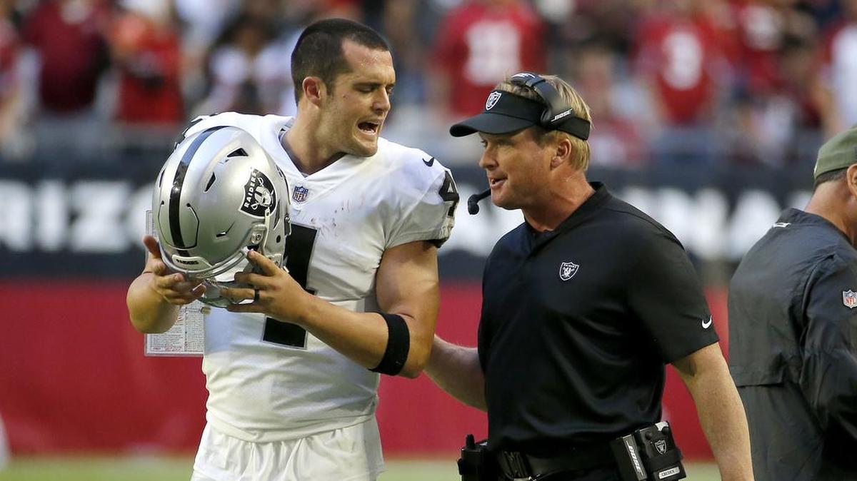 Oakland Raiders quarterback Derek Carr talks with coach Jon Gruden during the second half of Sunday’s game.