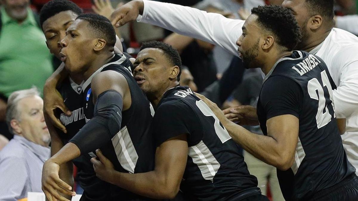 Providence forward Rodney Bullock, second from left, is mobbed by teammates after the Friars knocked off USC on Thursday, March 17, 2016 in Raleigh, N.C. Bullock hit the game-winning basket with 1.5 seconds left.