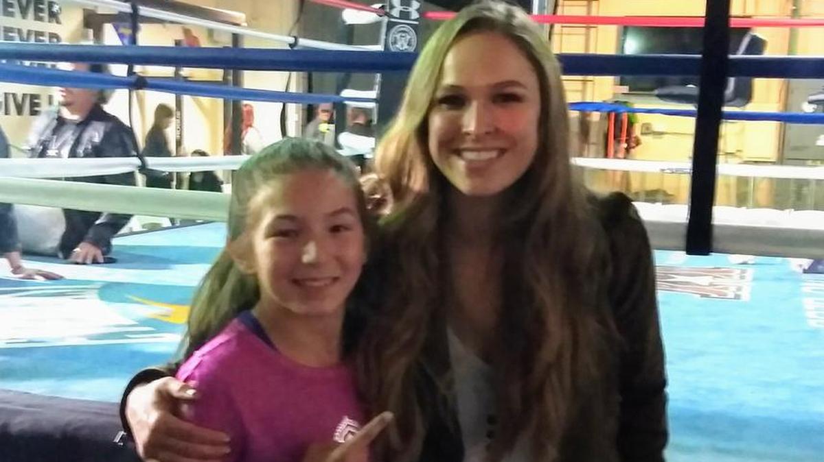 Jeannah Creason poses with her role model former UFC champion and WWE star Ronda Rousey.