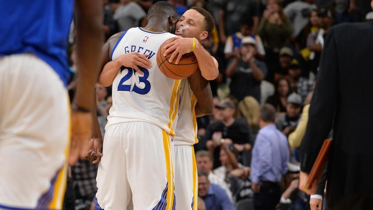 Golden State Warriors guard Stephen Curry, right, and Draymond Green embrace after beating the San Antonio Spurs in an NBA basketball game Sunday, April 10, 2016, in San Antonio. Golden State won 92-86 to tie the 1995-96 Chicago Bulls with 72 regular-season NBA wins.