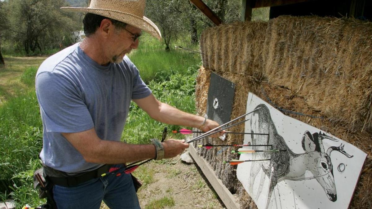Van Dement pulls arrows from a target at the Fresno Field Archers Club in the foothills near Dunlap. The archers will host their 60th annual Safari Shoot April 30-May 1.
