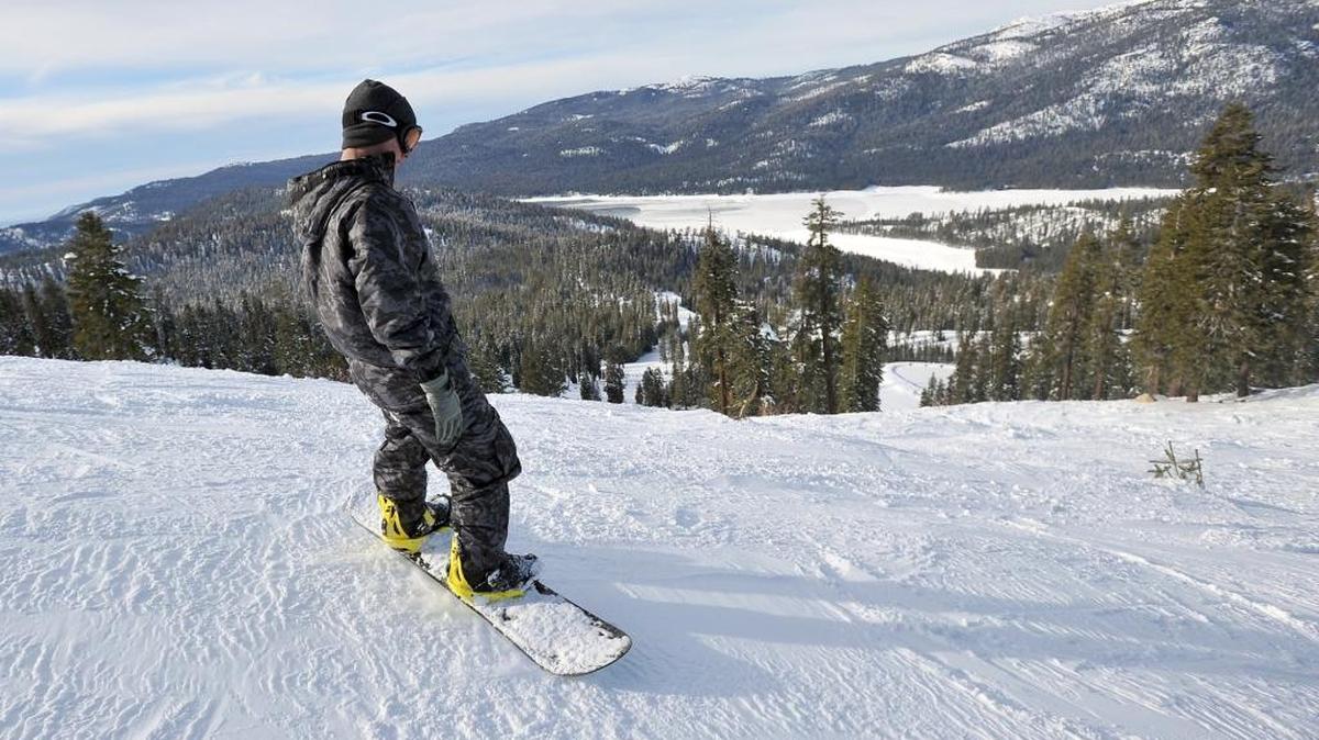A snowboarder begins his descent down the mountain at China Peak Mountain Resort near Huntington Lake in 2015. The resort is expected to open early next month for the 2016-17 snow-play season.