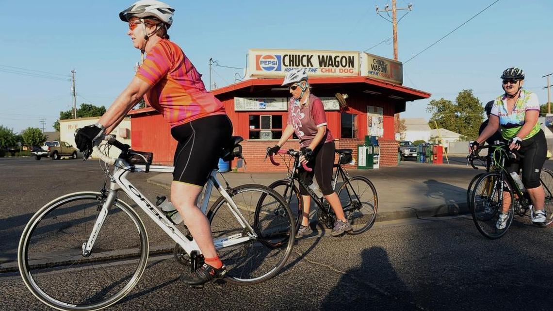 Riders pause at a stoplight in Sanger on Academy Avenue during the fifth annual Tour de Fresno Charity Bike Ride in 2013. The Tour de Fresno has announced that it has moved the start of the race to Kingsburg, with the 2016 edition scheduled for Sept. 17.