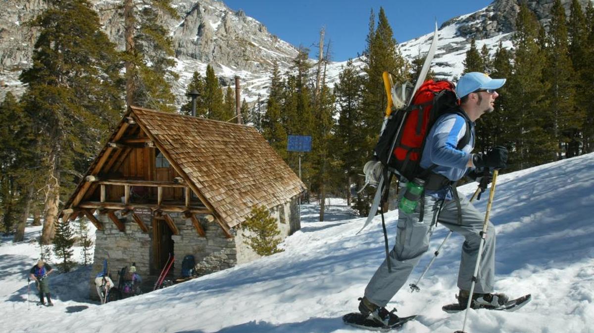 First crack at reservations for Pear Lake Ski Hut will be decided Nov. 1 through the annual lottery. The backcountry cabin sleeps 10. In this 2007 photo, Hanford’s Brian Monty carries his snowboard on his pack as he trudges up the mountain.