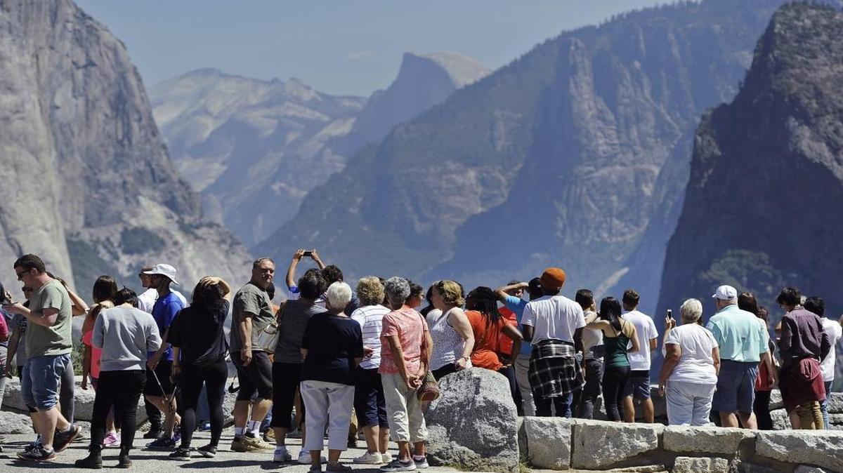 Yosemite had a record number of visitors in 2016. Visitors gather to take photographs at Tunnel View overlooking Yosemite Valley on Aug. 25, the day Yosemite National Park, staff and visitors celebrated the National Park Service’s 100-year anniversary.