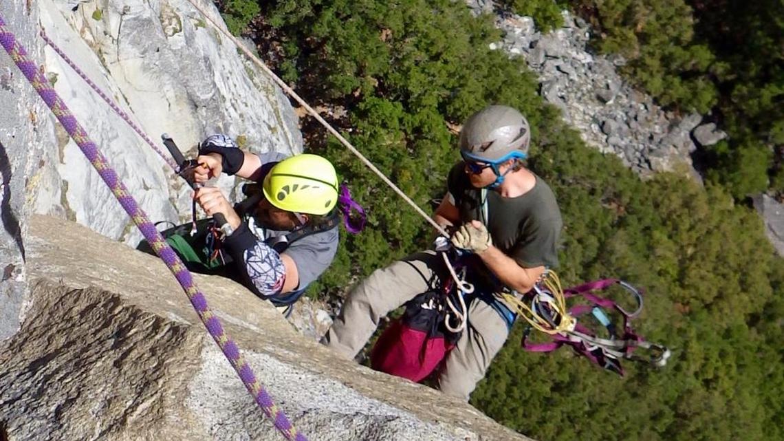 Enock Glidden, left, climbs up Yosemite National Park’s Washington Column in October 2015 by use of a metal bar attached to a mechanical ascender.