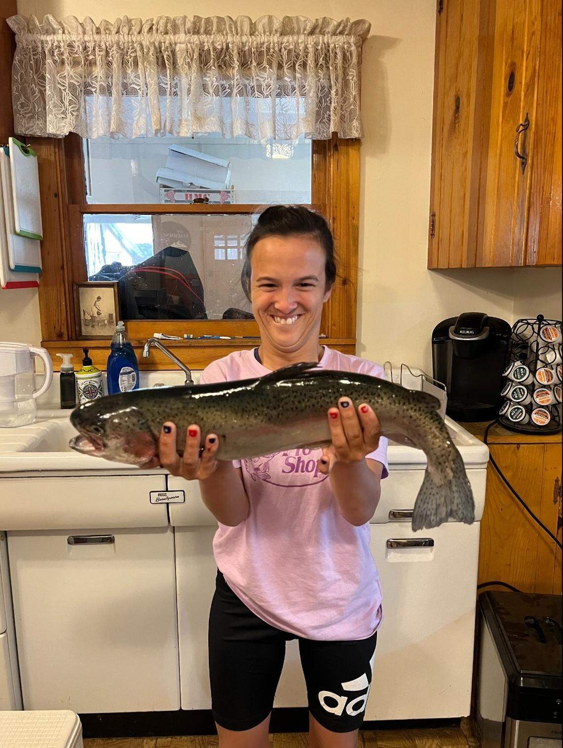Nancy Henson Daddino of Fresno shows a trophy trout she caught that was one of those planted at Shaver Lake about a week ago.