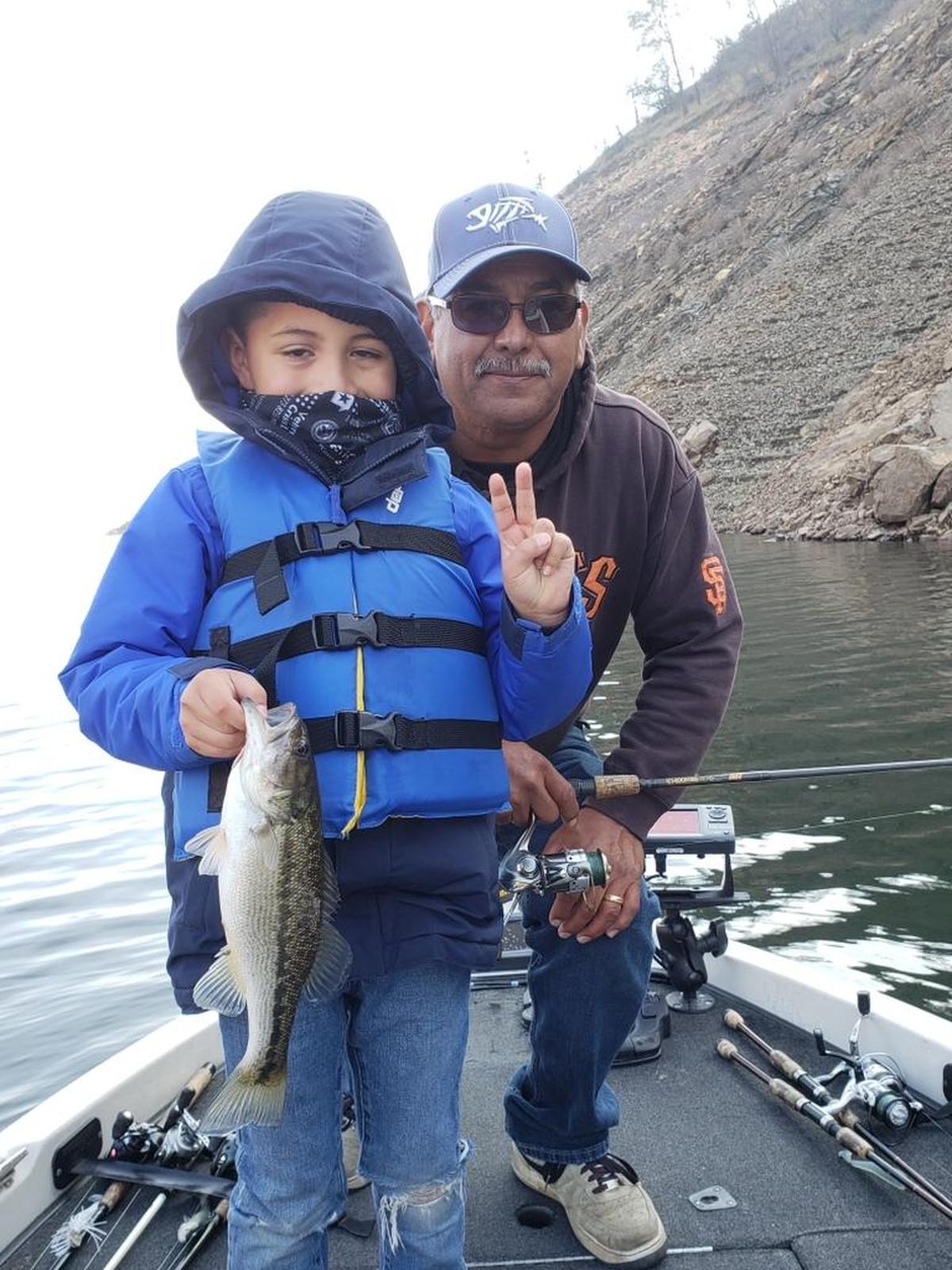 Six-year-old Noah Perez shows off his first-ever catch along with his grandfather Jesse Perez, caught Dec. 24 at 11:15 a.m. at Pine Flat Lake. Noah used a green pumpkin red flake hula grub in 40 feet of water, Jesse Perez says.