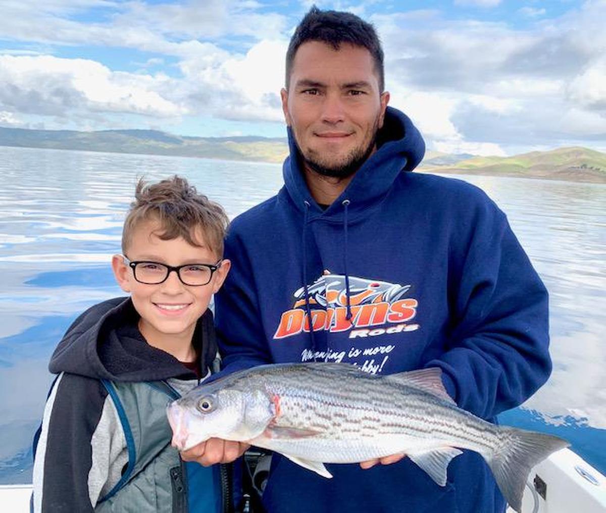 Jayar Salazar and son Mason, 10, show off a catch at San Luis Reservoir.