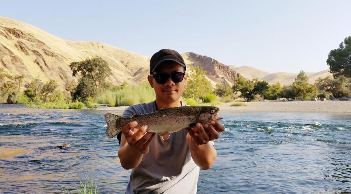 Sam Soeun shows off a rainbow trout caught Aug. 17 on the Kings River across from Winton Park. He used rainbow Powerbait.