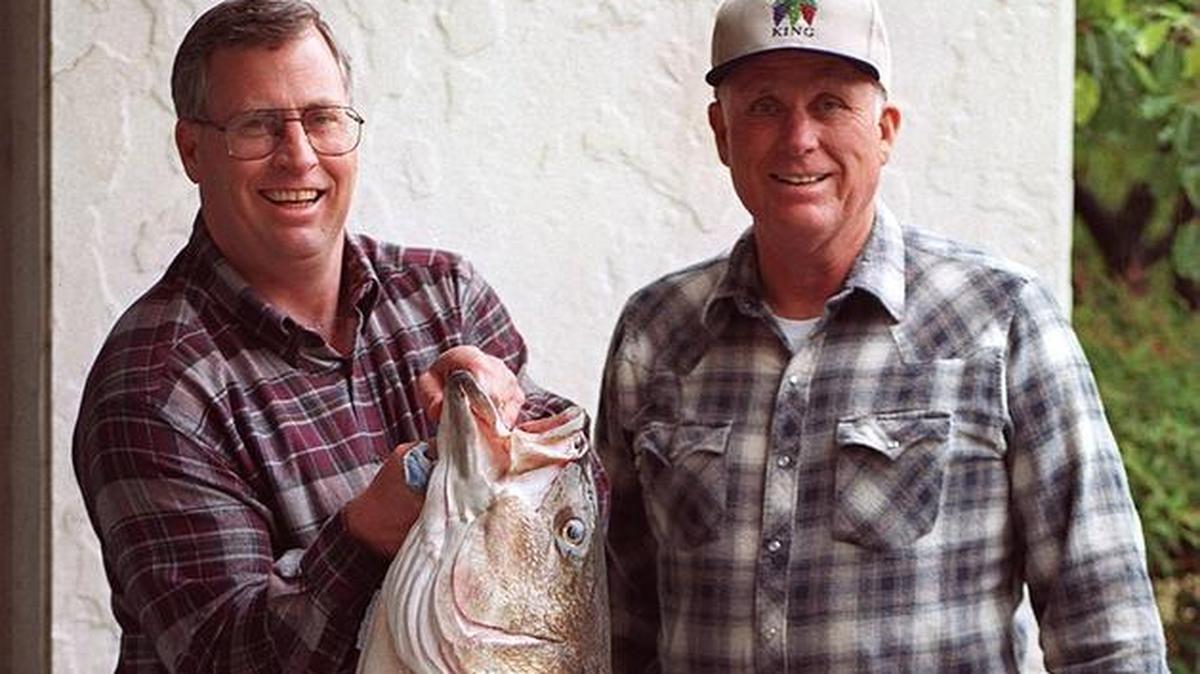 Roger George, left, and his father, Warren, enjoyed many fishing adventures. Here they show off a 1998 catch, a 42-inch, 50.3-pound striper caught at Millerton Lake.