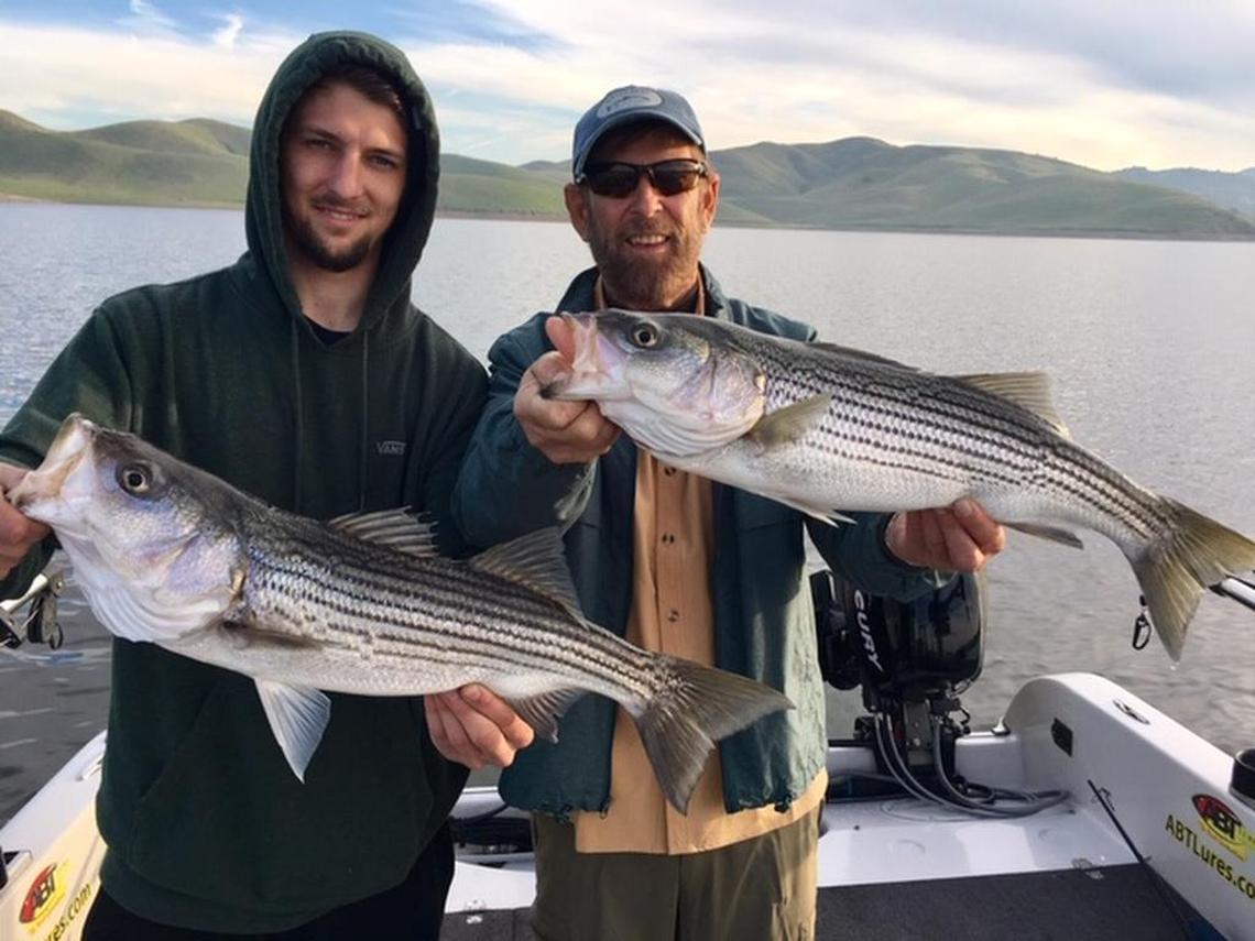 Bob Hawkins of Fresno, right, and his son Ryan show off their “twin” catches from last week at San Luis Reservoir.