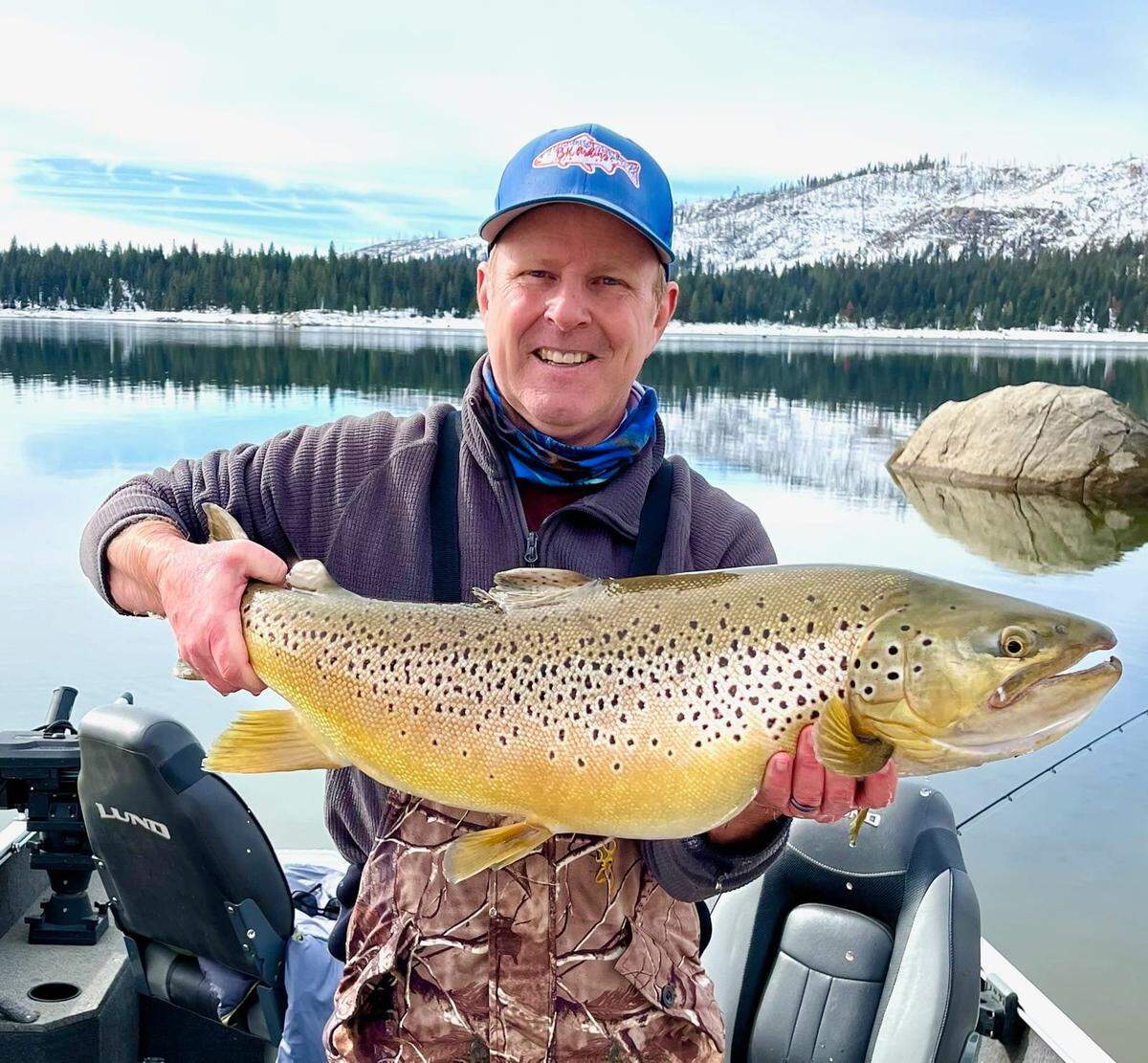 Byron Stickler of Fresno displays an 18-pound, 5-ounce brown trout he caught and released back in Shaver Lake in January.