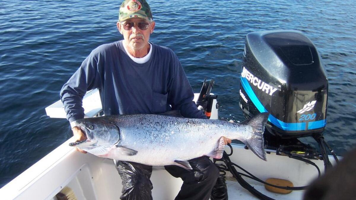 Ron Huston shows off the king salmon he caught in Shelter Cove using a sardine.