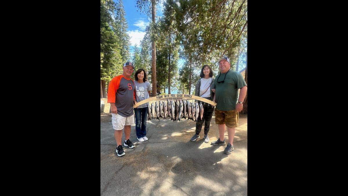 Two couples pose with their 15 kokanee catch with guide Paul Brown, of Fishing With Paul Guide Service. Brown has been on a recent roll providing guests with limits of kokanee.