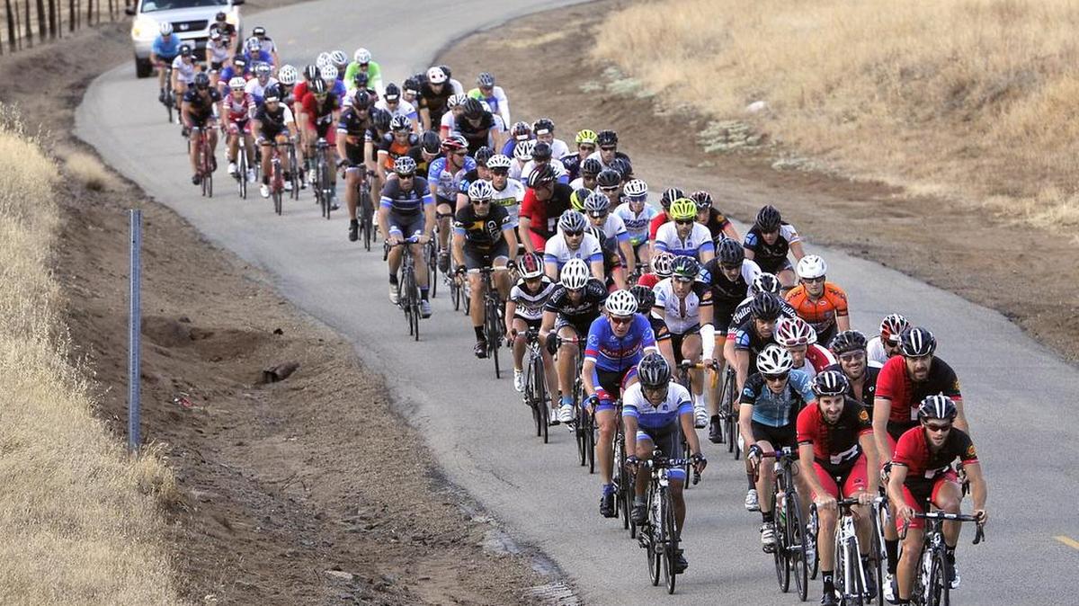 The peloton of the first riders in the 2015 Climb To Kaiser ride head up a section of Watts Valley Road during the 155-mile ride.