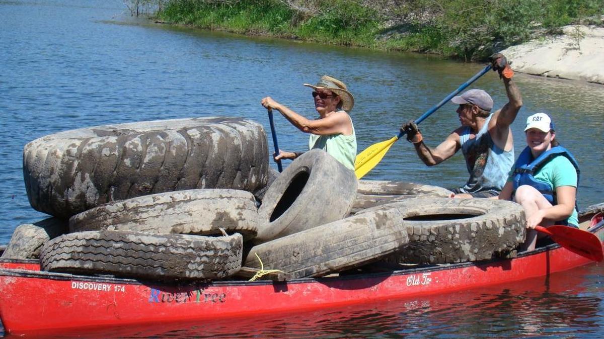 
Volunteers paddle with giant tires pulled from the San Joaquin River during the 2011 Great Sierra River Cleanup. Across the state, nearly 3,000 volunteers collected more than 61 tons in the seventh annual event on Saturday, Sept. 19, 2015.
