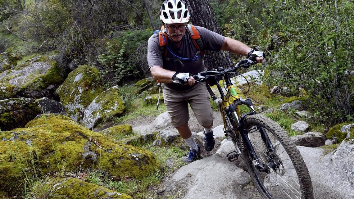 Bill Tanner of Fresno walks his bike back along the San Joaquin River Trail's singletrack course Tuesday, March 20, 2017, after a test run for this weekend's Big Sandy Race west of Auberry, Calif.