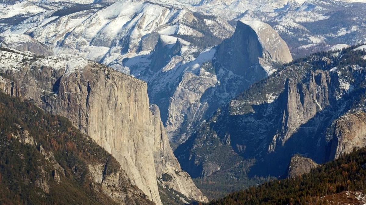 El Capitan, left, and Half Dome are seen in Yosemite Valley from the perspective of a helicopter looking east toward the Sierra Nevada mountains in this Fresno Bee file photo.